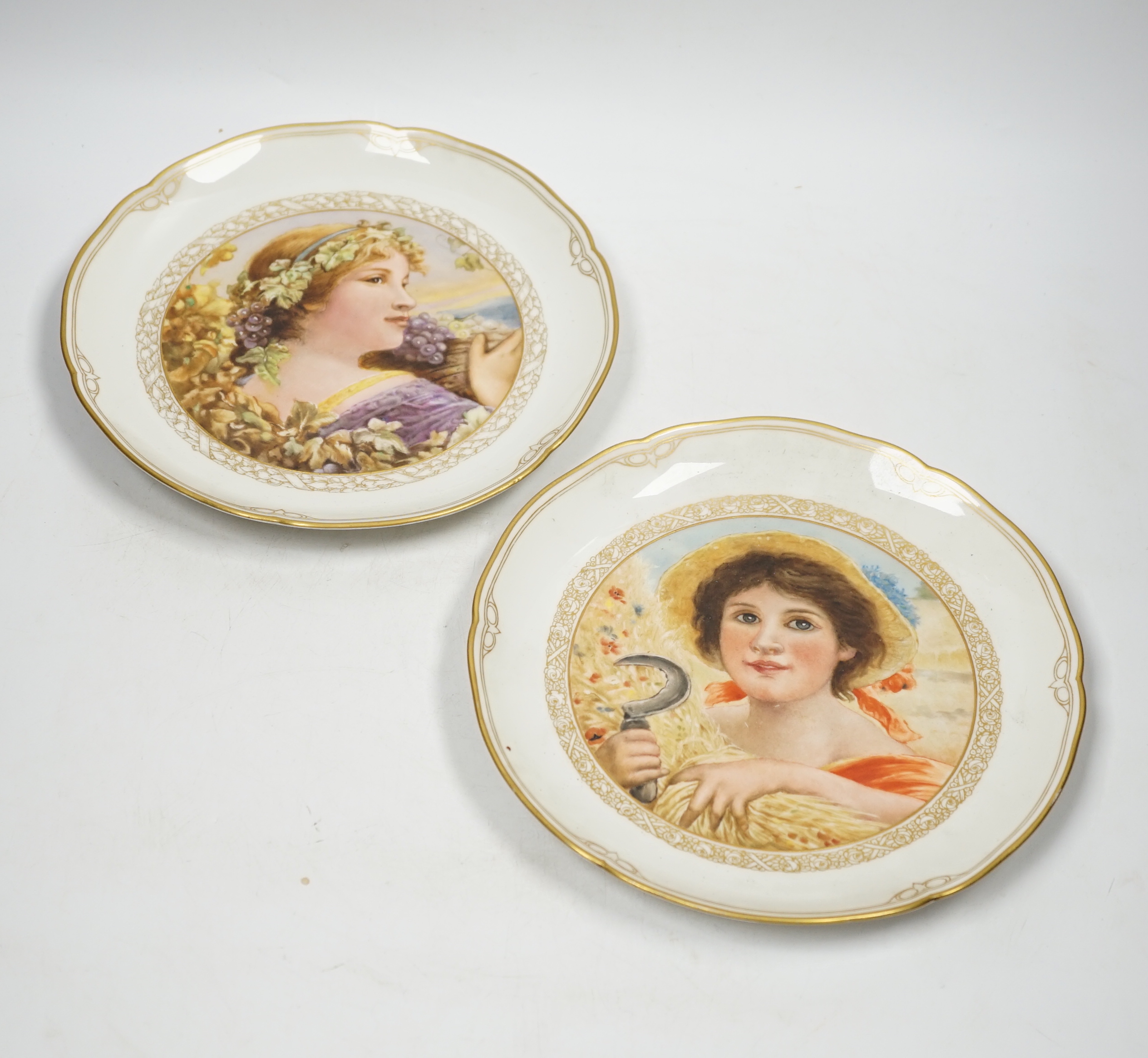 A pair of late 19th century Berlin plates, hand painted with females, 21.5cm